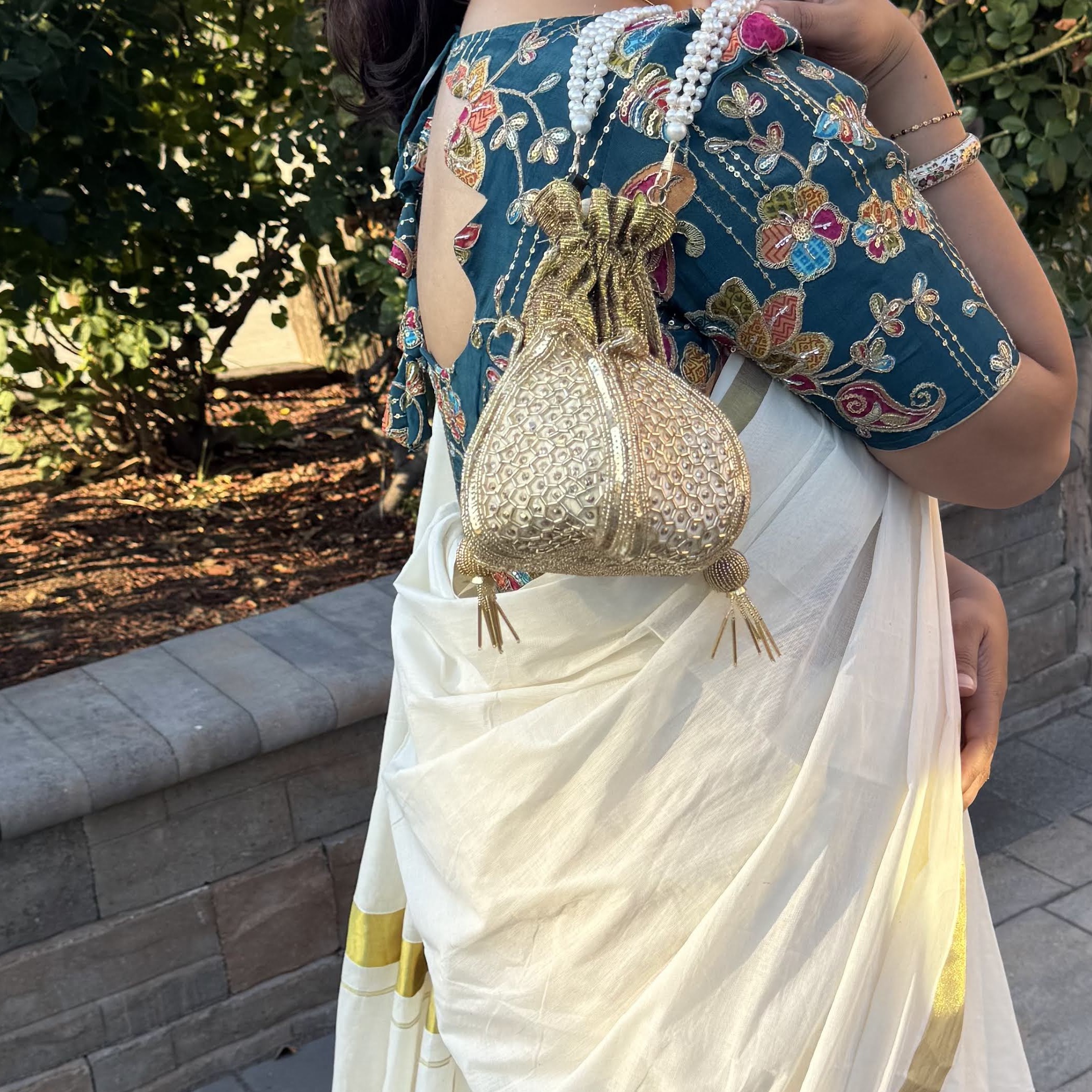 Model carrying the Lotus Gold VARNA Potli