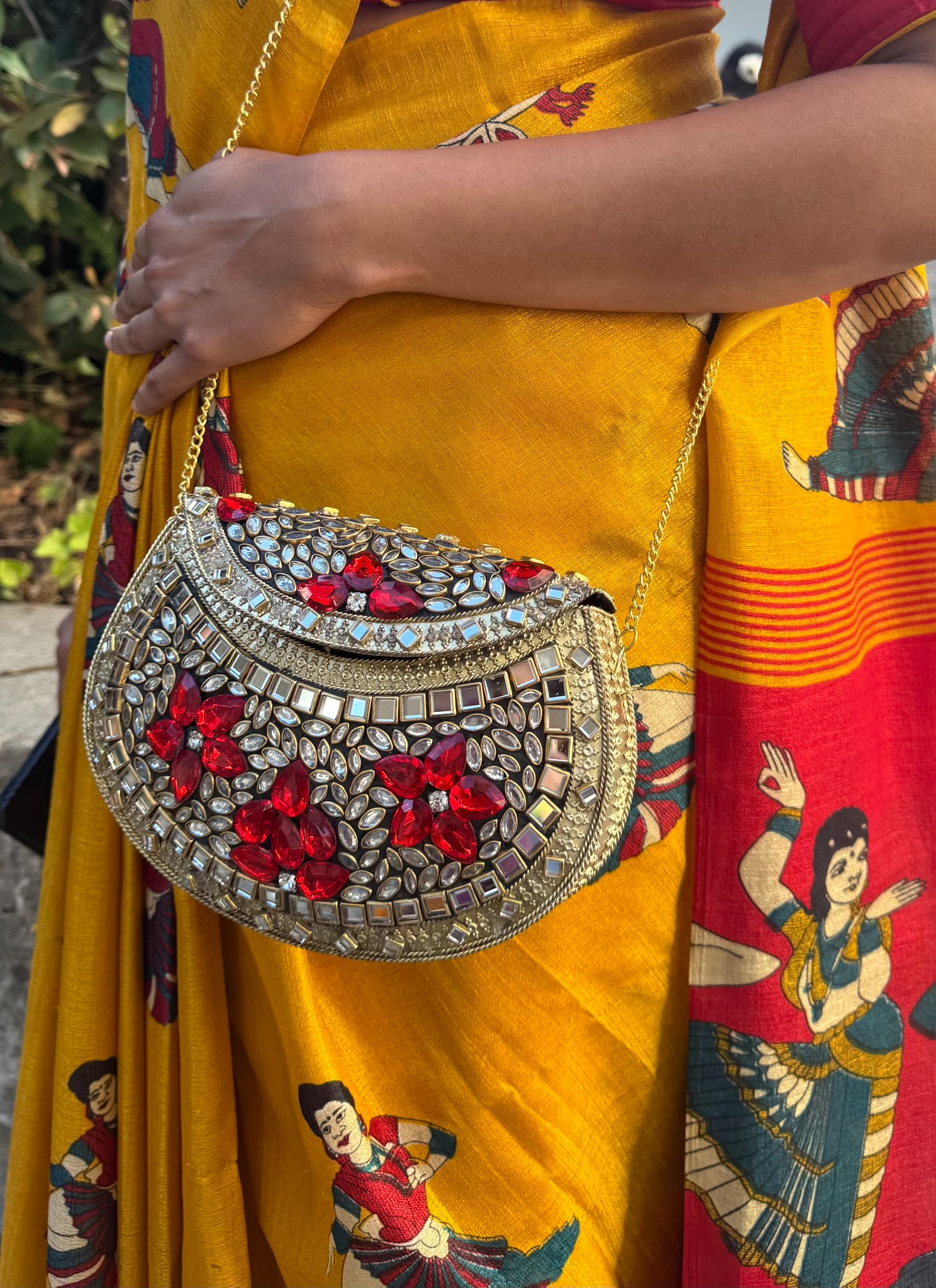 VARNA Kundan statement bag styled with a mustard sari